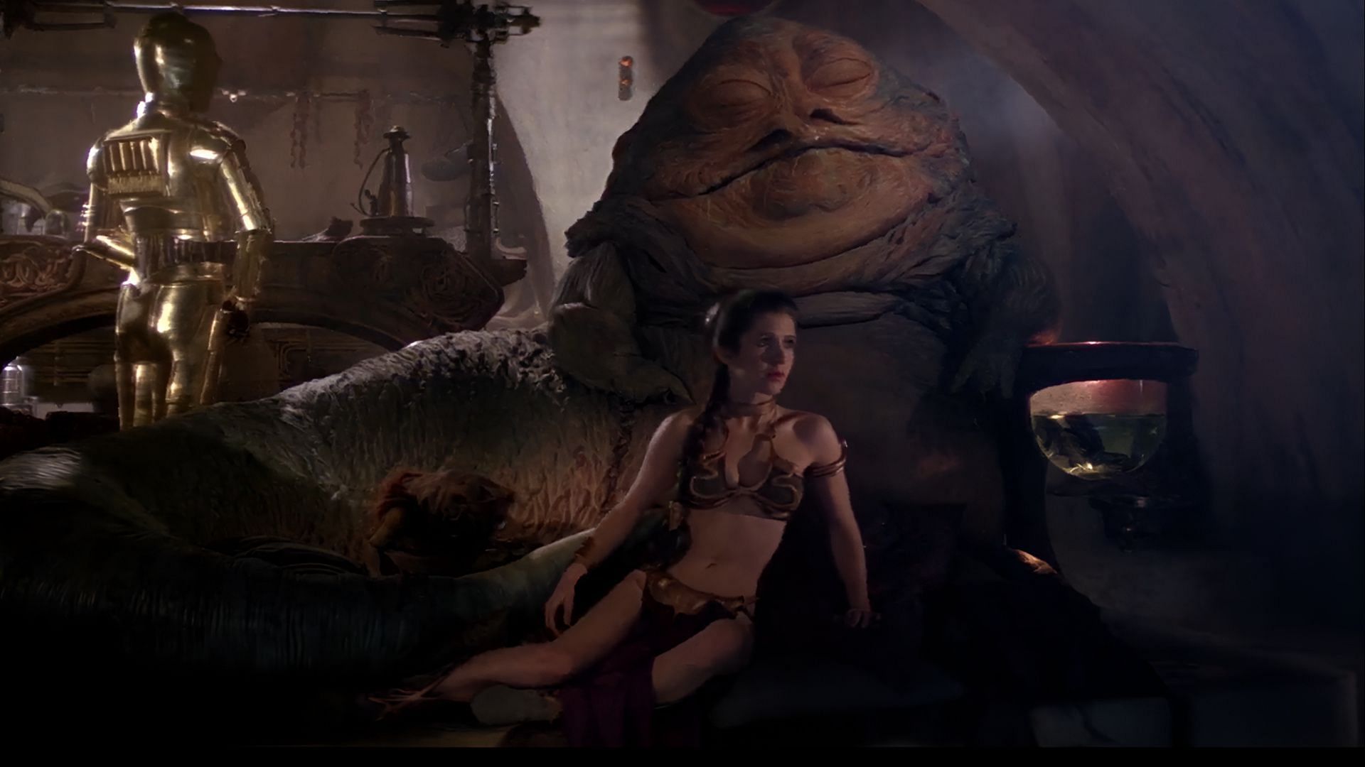 Leia in golden bikini with Jabba the Hutt in Star Wars: Return of the Jedi. (Image via Disney+)